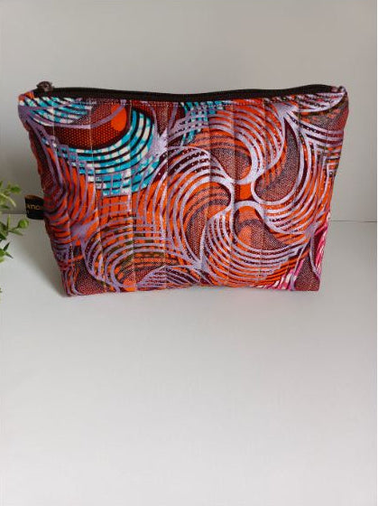 Trousse matelassée en wax et imperméable colorée